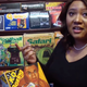 Image of woman standing in front of cabinet filled with boxes of LCD and handheld games.